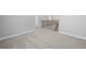 Neutral hallway features carpet and trim with access to multiple rooms throughout the home at 236 Begonia Way, Mcdonough, GA 30253