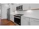 Modern kitchen showcasing stainless steel appliances, sleek countertops, and stylish white cabinetry at 236 Begonia Way, Mcdonough, GA 30253