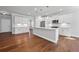 Spacious kitchen featuring white cabinets, stainless steel appliances, and a large center island with pendant lighting at 236 Begonia Way, Mcdonough, GA 30253