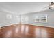 Bright living room with hardwood floors, large windows, and an open layout with a view of the backyard at 236 Begonia Way, Mcdonough, GA 30253
