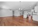 Expansive open-concept living space with hardwood floors and a kitchen featuring stainless steel appliances at 236 Begonia Way, Mcdonough, GA 30253