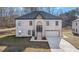 Two-story brick home with a large driveway and attached garage at 4400 Ross Estates Ct, Snellville, GA 30039