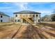 Two-story house with deck and stairs in the back at 4400 Ross Estates Ct, Snellville, GA 30039
