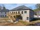 Two-story house with deck and stairs in the back at 4400 Ross Estates Ct, Snellville, GA 30039