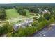Aerial image of golf course, parking and a clubhouse, featuring scenic landscaping and mature trees at 5669 Hollowbrooke Nw Ln, Acworth, GA 30101