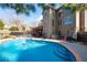 Backyard with a pool, spa, umbrella, patio furniture and a view of the home's exterior at 5669 Hollowbrooke Nw Ln, Acworth, GA 30101