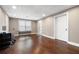 Finished basement area with hardwood floors, drop ceiling, and a window with blinds at 5669 Hollowbrooke Nw Ln, Acworth, GA 30101