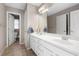 Bathroom with dual vanities, a large mirror, and tile flooring with neutral paint at 5669 Hollowbrooke Nw Ln, Acworth, GA 30101