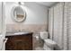 Bathroom features vanity, patterned shower curtain, tile floors and an oval mirror at 5669 Hollowbrooke Nw Ln, Acworth, GA 30101