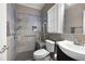 Accessible bathroom featuring a tiled shower, seat, and grab bars at 5669 Hollowbrooke Nw Ln, Acworth, GA 30101