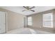 Bedroom features neutral walls, ceiling fan, carpet, and two windows with blinds at 5669 Hollowbrooke Nw Ln, Acworth, GA 30101