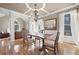 Spacious dining room with hardwood floors, wainscotting, and an elegant chandelier at 5669 Hollowbrooke Nw Ln, Acworth, GA 30101