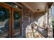 Inviting front porch featuring a stone facade, seating area, and decorative wreaths on the glass doors at 5669 Hollowbrooke Nw Ln, Acworth, GA 30101