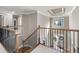 Bright hallway showcasing decorative tray ceilings, oak and iron stair rail, and front door view at 5669 Hollowbrooke Nw Ln, Acworth, GA 30101