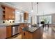 Eat-in kitchen featuring granite countertops, wooden cabinets, and tile backsplash at 5669 Hollowbrooke Nw Ln, Acworth, GA 30101