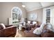 Inviting living room with large window, hardwood floors, and comfortable leather seating at 5669 Hollowbrooke Nw Ln, Acworth, GA 30101