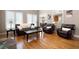 Spacious living room with hardwood floors and comfortable leather seating at 5669 Hollowbrooke Nw Ln, Acworth, GA 30101