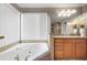 Main bathroom highlighting soaking tub with tile surround and vanity with granite countertops at 5669 Hollowbrooke Nw Ln, Acworth, GA 30101