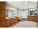 Bright main bathroom featuring dual vanities, a soaking tub, walk-in shower, and decorative tile floor at 5669 Hollowbrooke Nw Ln, Acworth, GA 30101