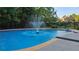 Sparkling pool with fountain feature, surrounded by well-maintained landscaping at 5669 Hollowbrooke Nw Ln, Acworth, GA 30101