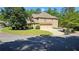 View of the three-car garage with long driveway and well-kept lawn at 5669 Hollowbrooke Nw Ln, Acworth, GA 30101