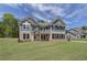 Two-story home with gray siding, brick accents, and a landscaped lawn at 62 Homesite Cooper W Cv, Fayetteville, GA 30215