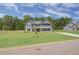 Two-story home with gray siding, brick accents, and a landscaped lawn at 62 Homesite Cooper W Cv, Fayetteville, GA 30215