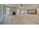 Open living room with fireplace and wood-look floors at 72 Homesite Cooper W Cv, Fayetteville, GA 30215