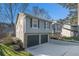 Two-car garage and driveway of a renovated house with gray siding at 1004 Mainstreet Lake Dr, Stone Mountain, GA 30088