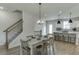 Farmhouse style dining room with wooden table and chairs, adjacent to kitchen at 1238 Ainsworth Aly # 38, Sugar Hill, GA 30518