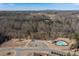 Community aerial view of a neighborhood pool, playground, parking area, and many trees and shrubs at 4770 Alford Commons, Cumming, GA 30028