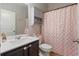Cozy bathroom with stylish vanity, updated fixtures, and a decorative pink shower curtain for a charming touch at 4770 Alford Commons, Cumming, GA 30028
