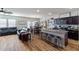 Open kitchen features granite countertops, stainless steel appliances, and an island with seating at 4770 Alford Commons, Cumming, GA 30028