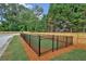 Enclosed dog park with turf and wood fencing at 712 Fairgate Rd, Marietta, GA 30064