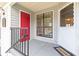 Front entrance with red door, window, and white screen door at 730 Windchase Ln, Stone Mountain, GA 30083