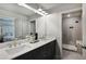 Bathroom featuring double vanity, granite counters, with walk in shower at 907 E Green Ln, Clarkston, GA 30021