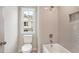 Bathroom featuring tiled shower and tub combination with a view from the window at 907 E Green Ln, Clarkston, GA 30021