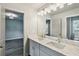 Bathroom vanity featuring dual sinks, modern fixtures and bright lighting at 907 E Green Ln, Clarkston, GA 30021