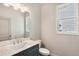 Stylish bathroom with marble countertop, vanity and large mirror with great lighting at 907 E Green Ln, Clarkston, GA 30021