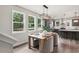 Sunlit dining area open to the kitchen with ample seating and views of the outdoors at 907 E Green Ln, Clarkston, GA 30021