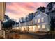 Row of charming homes featuring manicured yards and covered porches with beautiful sunset sky at 907 E Green Ln, Clarkston, GA 30021