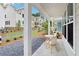 Inviting front porch with quaint seating and a view of the meticulously landscaped community at 907 E Green Ln, Clarkston, GA 30021