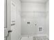 Bright laundry room featuring stylish tile flooring and a convenient wire shelf for storage at 907 E Green Ln, Clarkston, GA 30021