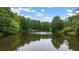 Scenic community pond surrounded by lush green trees and landscaping at 907 E Green Ln, Clarkston, GA 30021