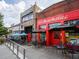 Exterior view of local restaurants with outdoor seating and colorful awnings at 907 E Green Ln, Clarkston, GA 30021