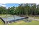 Community tennis courts, parking, playground and picnic area surrounded by mature trees at 907 E Green Ln, Clarkston, GA 30021