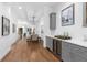 Gray built-in bar with wine fridge, hardwood floors, and dining table at 965 Boulevard # A, Atlanta, GA 30312