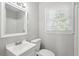 Updated bathroom with white vanity and window at 3563 Bolfair Nw Dr, Atlanta, GA 30331