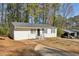 Front yard view of a freshly painted white house with a carport at 3563 Bolfair Nw Dr, Atlanta, GA 30331