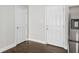 Hallway with dark hardwood floors and white doors at 3563 Bolfair Nw Dr, Atlanta, GA 30331
